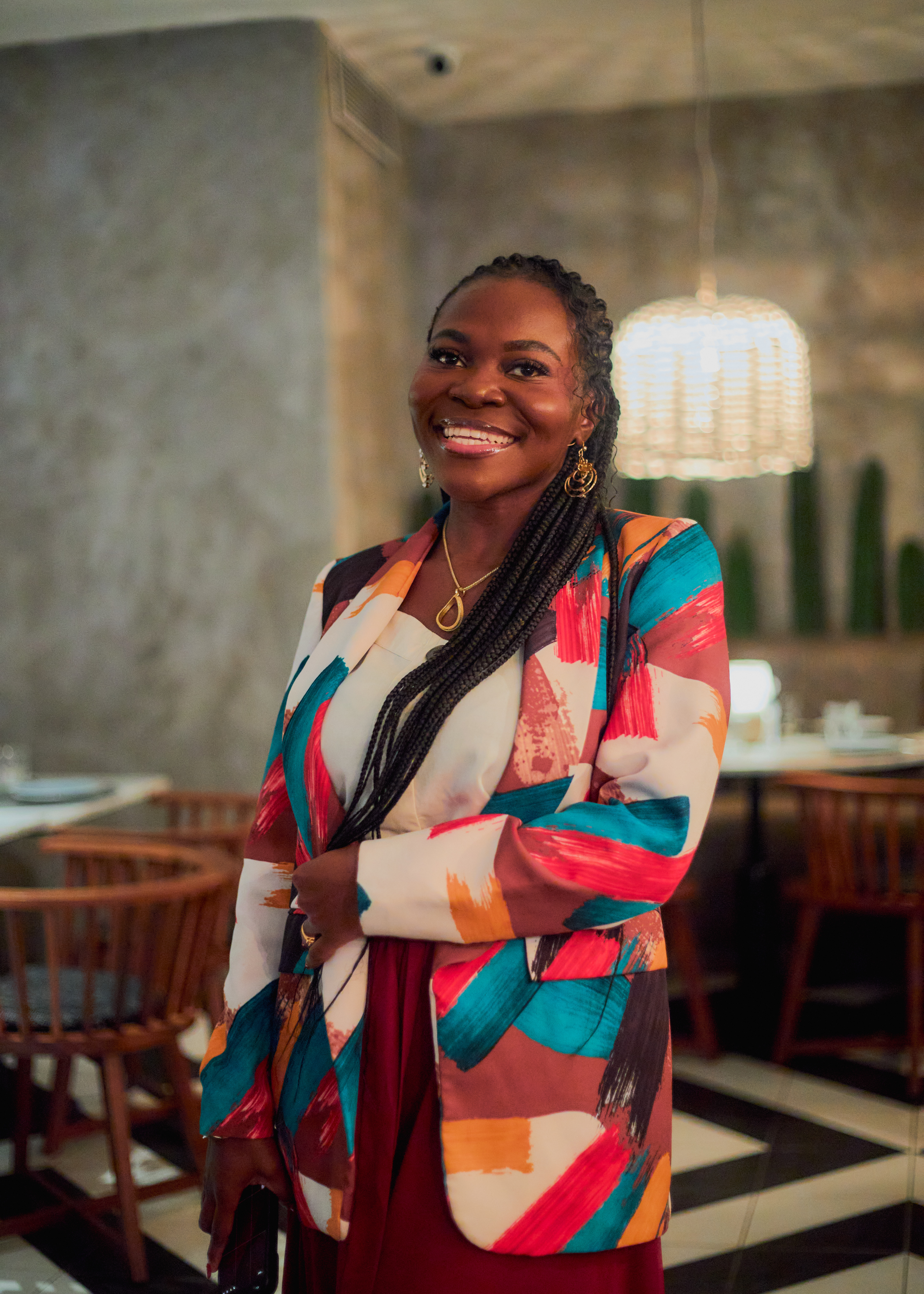Abbie smiling in a colourful patterned dress